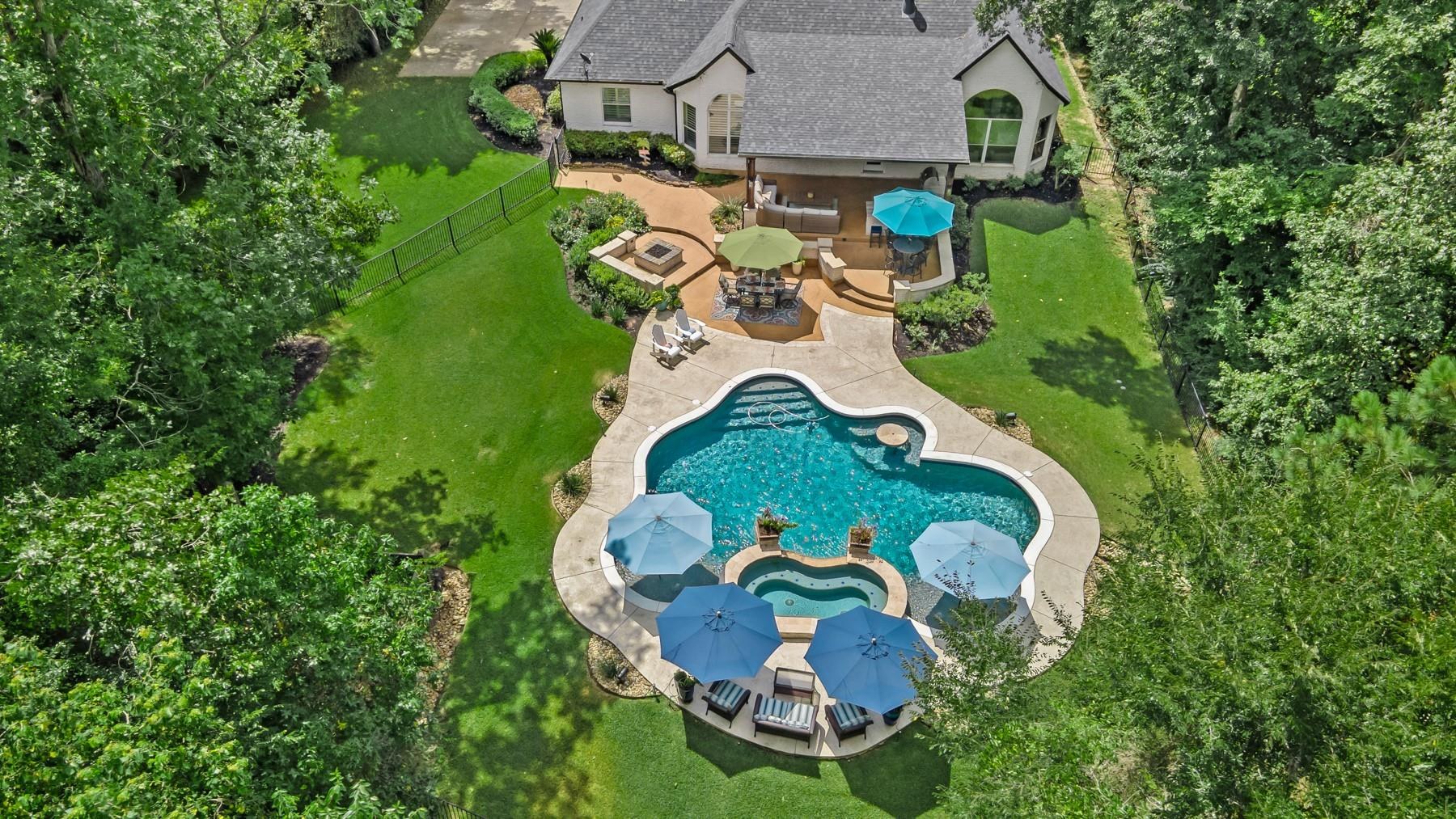 An aerial view of a Montgomery, Texas home with a pool